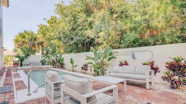 view of pool featuring a patio area, a fenced backyard, and outdoor lounge area