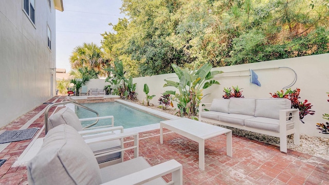 view of pool with a patio, a fenced backyard, an outdoor living space, and a fenced in pool