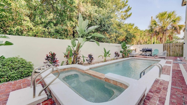 view of swimming pool featuring a fenced in pool, a fenced backyard, grilling area, an in ground hot tub, and a patio area