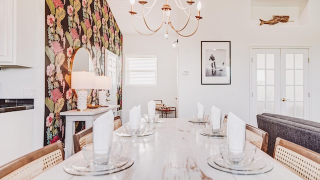 dining space featuring a chandelier and french doors