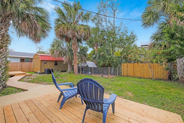 wooden deck with a storage shed and a yard