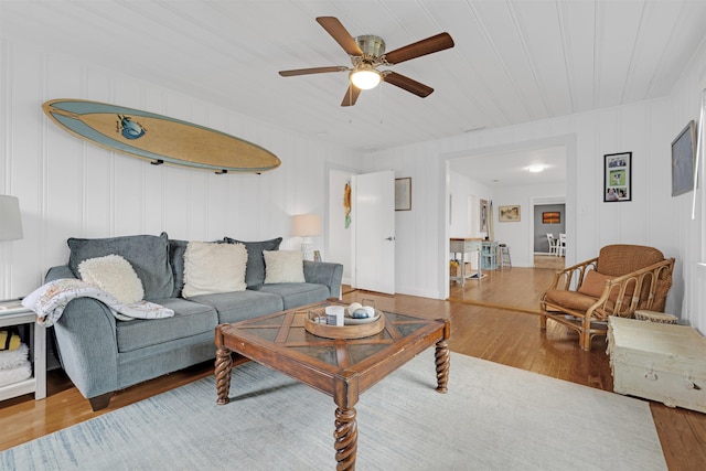 living room featuring hardwood / wood-style flooring, ceiling fan, and wood ceiling