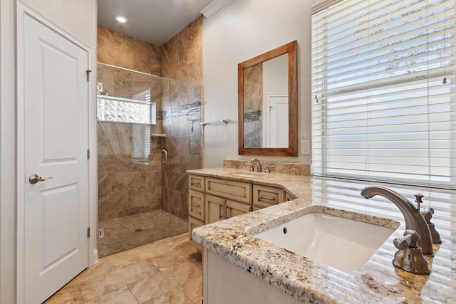 bathroom with vanity and a shower with shower door