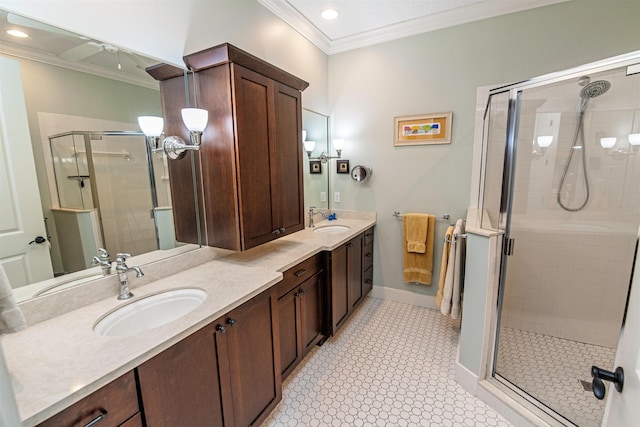 full bath with ornamental molding, a stall shower, and a sink