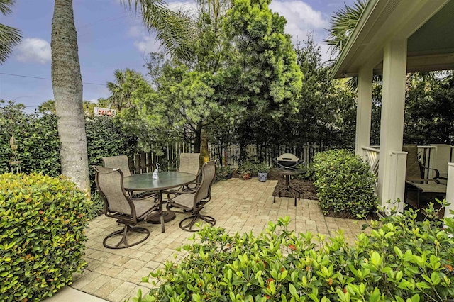 view of patio with outdoor dining space and fence