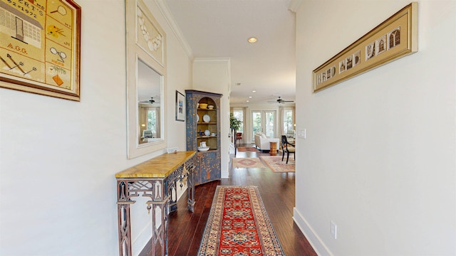 hallway featuring recessed lighting, baseboards, dark wood-style flooring, and crown molding