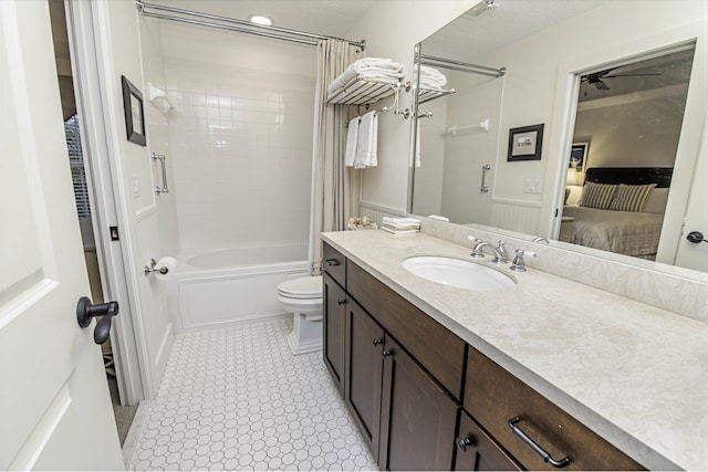 ensuite bathroom with vanity, toilet, shower / bath combo, and ensuite bathroom