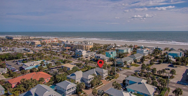 birds eye view of property with a water view and a view of the beach