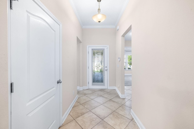 doorway featuring crown molding, light tile patterned floors, and baseboards