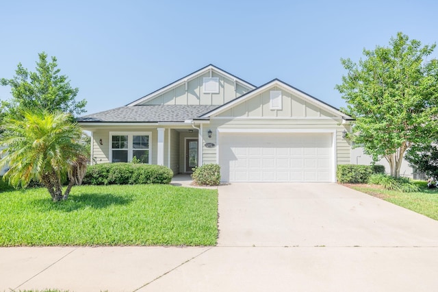 view of front facade with board and batten siding, an attached garage, a front lawn, and driveway
