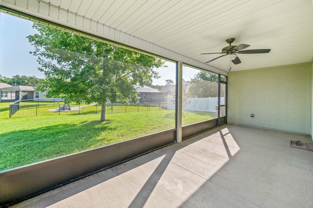 unfurnished sunroom with a ceiling fan