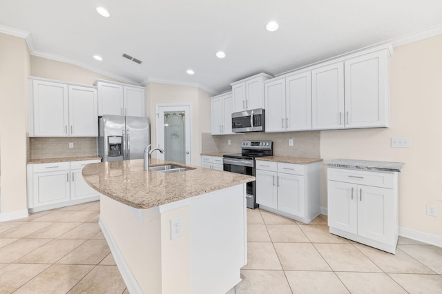 kitchen with appliances with stainless steel finishes, a sink, crown molding, vaulted ceiling, and tasteful backsplash