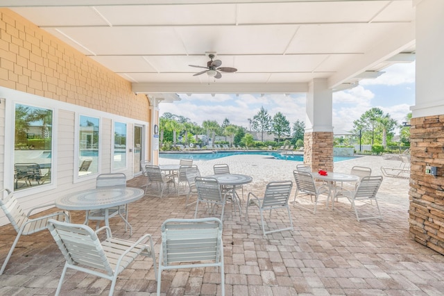 view of patio / terrace featuring a ceiling fan and a community pool