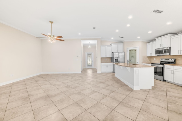 kitchen with stainless steel appliances, a sink, backsplash, crown molding, and recessed lighting