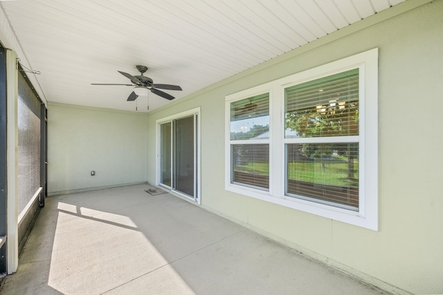 unfurnished sunroom with ceiling fan