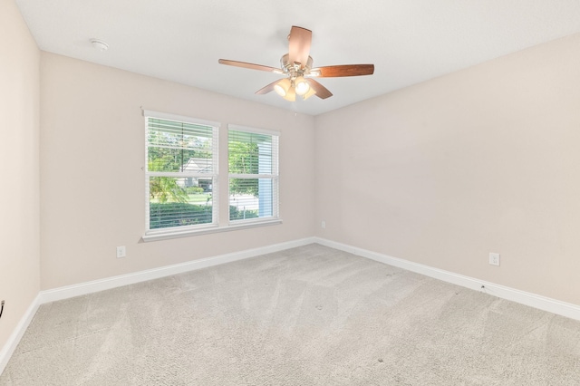 unfurnished room with ceiling fan, baseboards, and carpet floors
