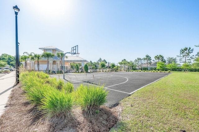 view of sport court featuring community basketball court and a lawn