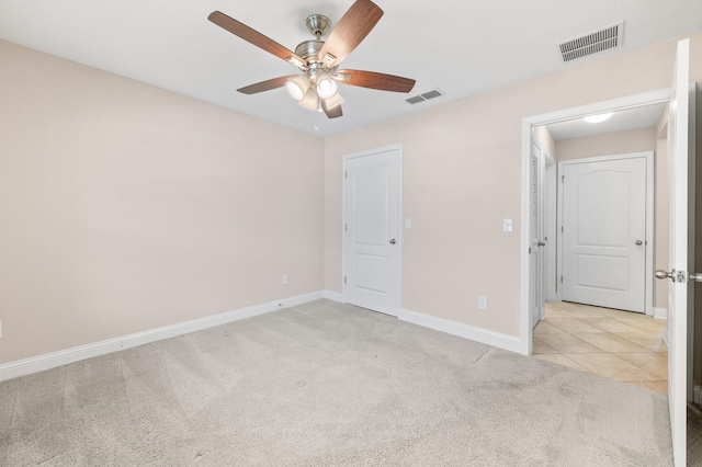 unfurnished bedroom with light carpet, baseboards, and ceiling fan