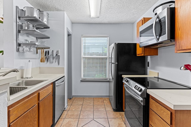 kitchen featuring sink, light tile patterned floors, and stainless steel appliances