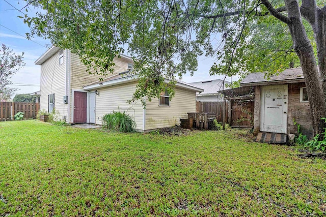 rear view of house featuring a yard