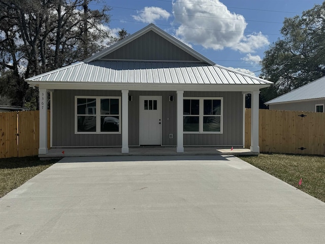 237 Jackson Blvd, Saint Augustine, FL 32095 - view of front of home with metal roof, a porch, and fence