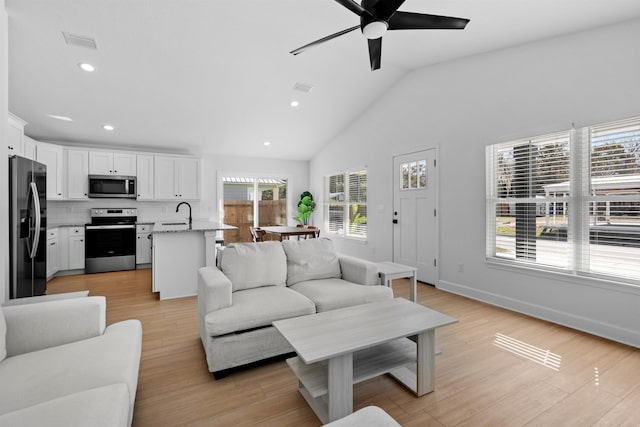 237 Jackson Blvd, Saint Augustine, FL 32095 - living area with lofted ceiling, light wood-style flooring, baseboards, visible vents, and a ceiling fan