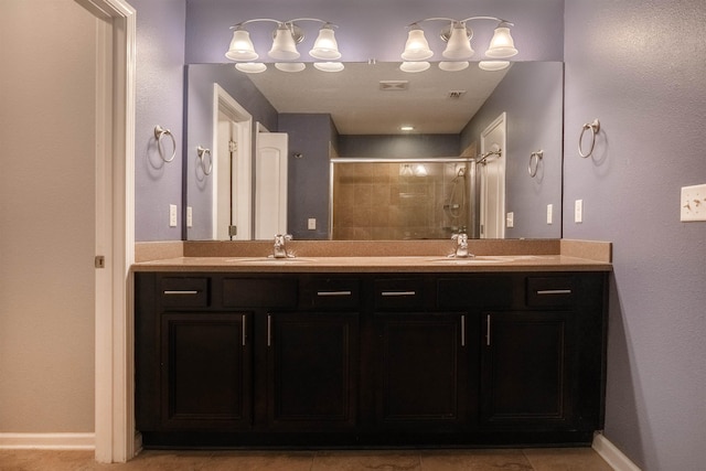 bathroom with vanity, tile patterned floors, and a shower with shower door