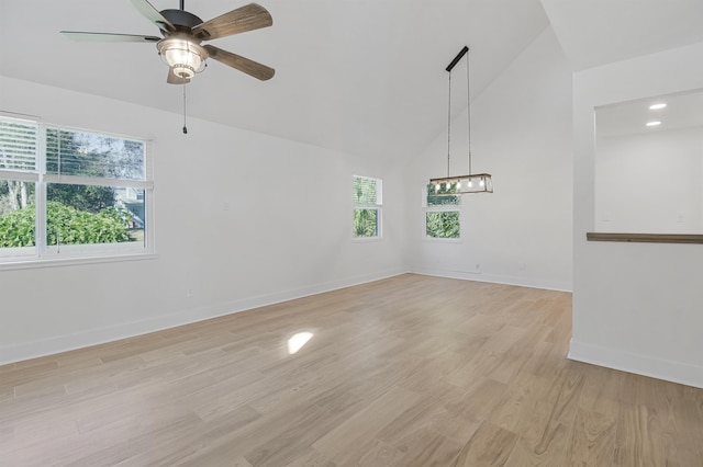 155 Drake Rd, Saint Augustine, FL 32086 - empty room with a chandelier, light wood finished floors, high vaulted ceiling, ceiling fan, and baseboards
