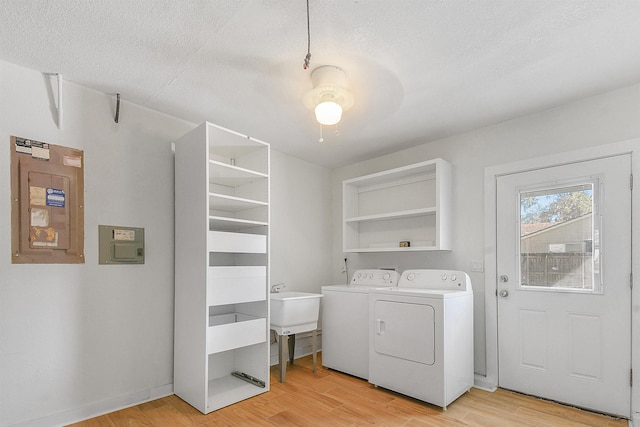 155 Drake Rd, Saint Augustine, FL 32086 - washroom featuring washing machine and clothes dryer, light wood-style floors, a textured ceiling, and electric panel