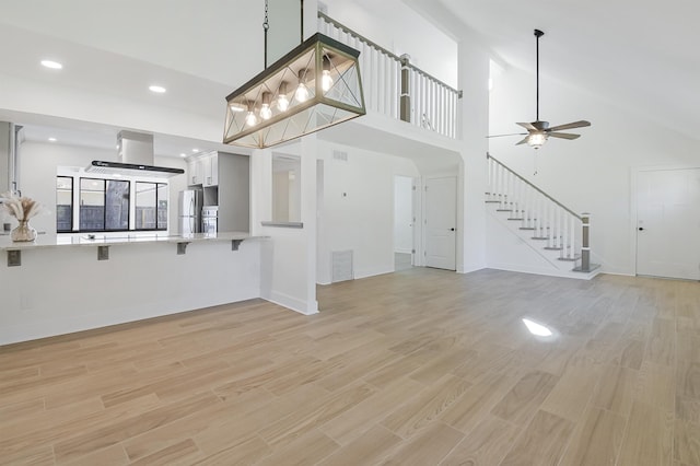 155 Drake Rd, Saint Augustine, FL 32086 - unfurnished living room featuring light wood finished floors, a ceiling fan, stairway, recessed lighting, and baseboards