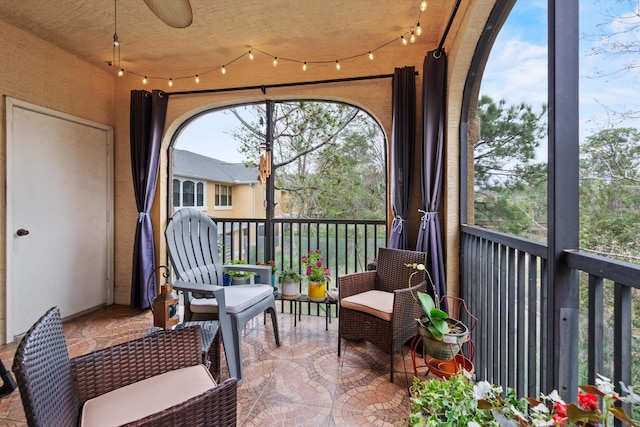 sunroom featuring track lighting and a ceiling fan