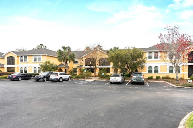 uncovered parking lot with a residential view