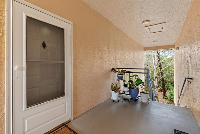 entrance to property featuring stucco siding