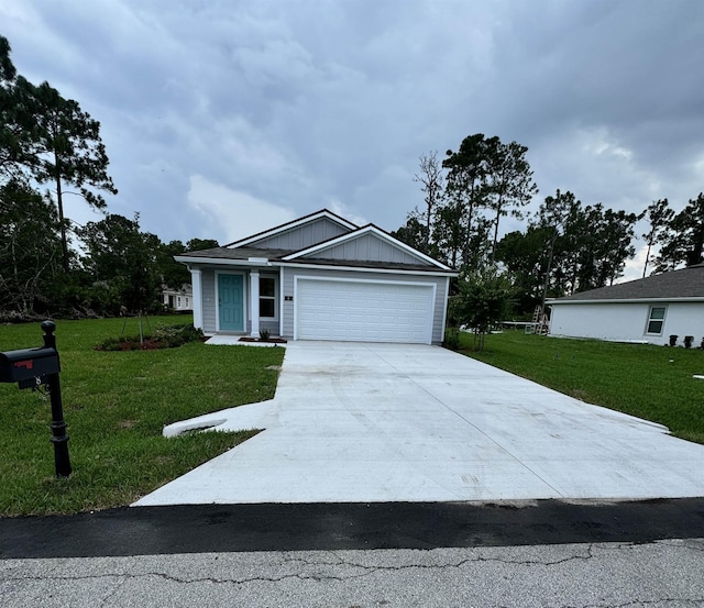 single story home with board and batten siding, a front yard, concrete driveway, and an attached garage