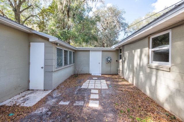 property entrance featuring concrete block siding