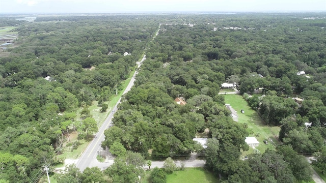 drone / aerial view featuring a wooded view