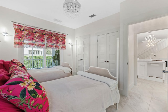 bedroom featuring a chandelier, marble finish floor, and visible vents