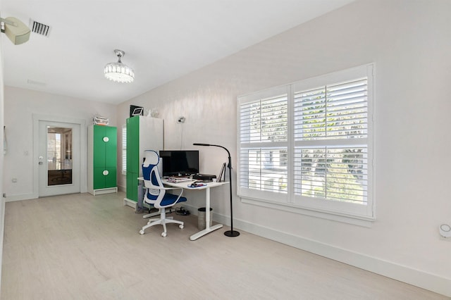 office featuring a chandelier, wood finished floors, visible vents, and baseboards