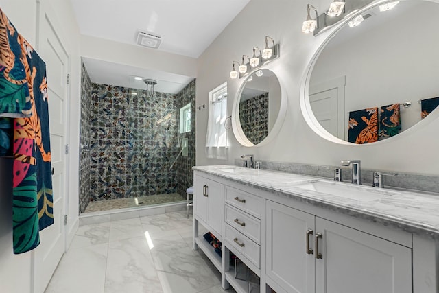 full bathroom with marble finish floor, a sink, a shower stall, and double vanity