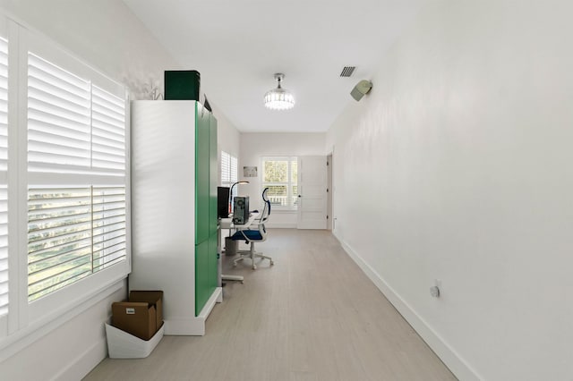 office featuring light wood-style floors, visible vents, and baseboards