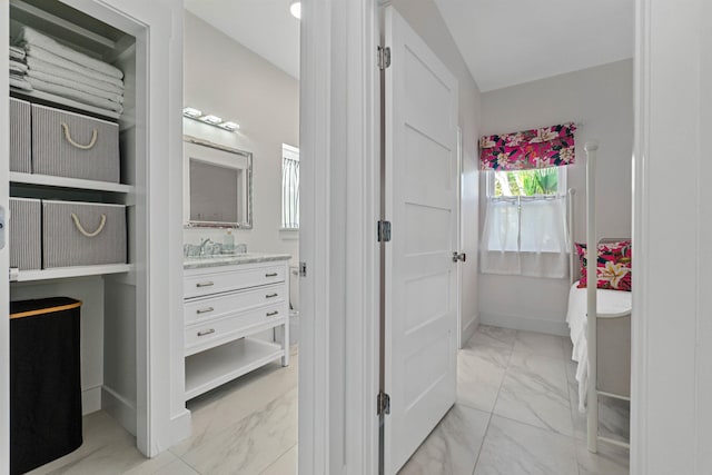 bathroom featuring marble finish floor, vanity, and baseboards