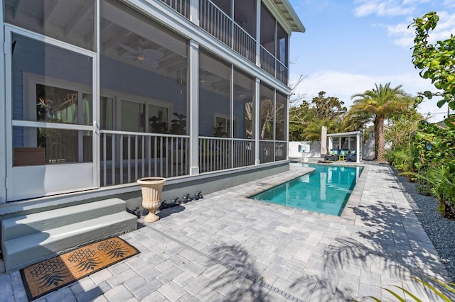 view of pool featuring a fenced in pool, a sunroom, and a patio area