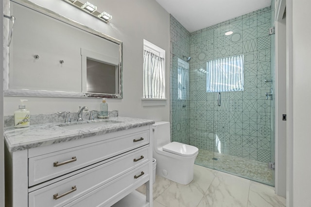 bathroom featuring marble finish floor, vanity, a shower stall, and toilet