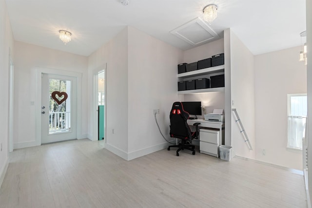 office with light wood-style flooring, baseboards, and attic access