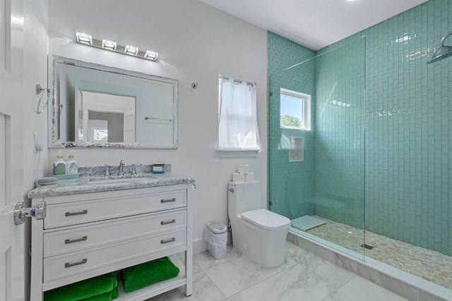 bathroom featuring marble finish floor, tiled shower, vanity, and toilet