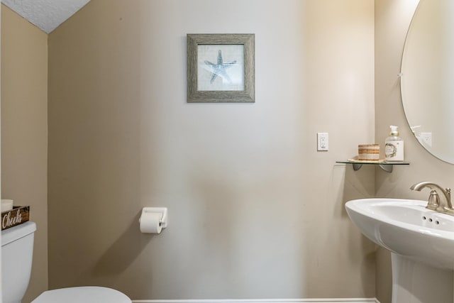 bathroom featuring sink and toilet