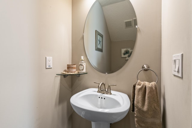 bathroom featuring sink and a textured ceiling