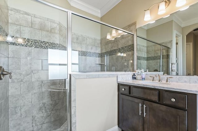 bathroom with vanity, ornamental molding, and walk in shower