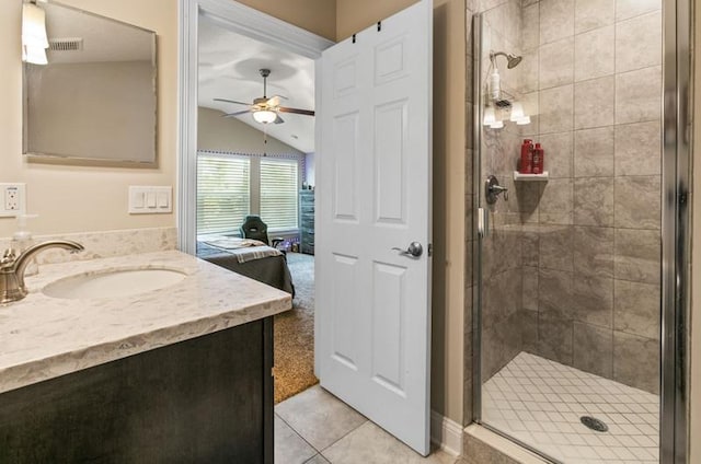 bathroom with lofted ceiling, tile patterned flooring, vanity, an enclosed shower, and ceiling fan