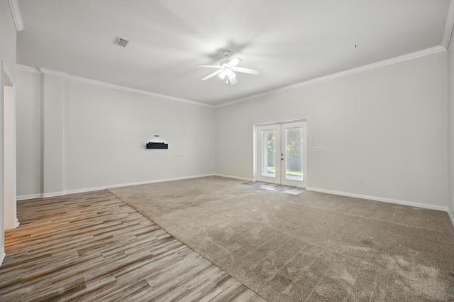 500 Seagate Ln, Saint Augustine, FL 32084 - unfurnished room featuring ceiling fan, french doors, wood finished floors, baseboards, and crown molding